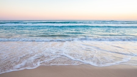 Turquoise ocean water laps at a clean sandy shore. A calm wave approaches the shore, which is what I envisioned when I did my dilator stretches.